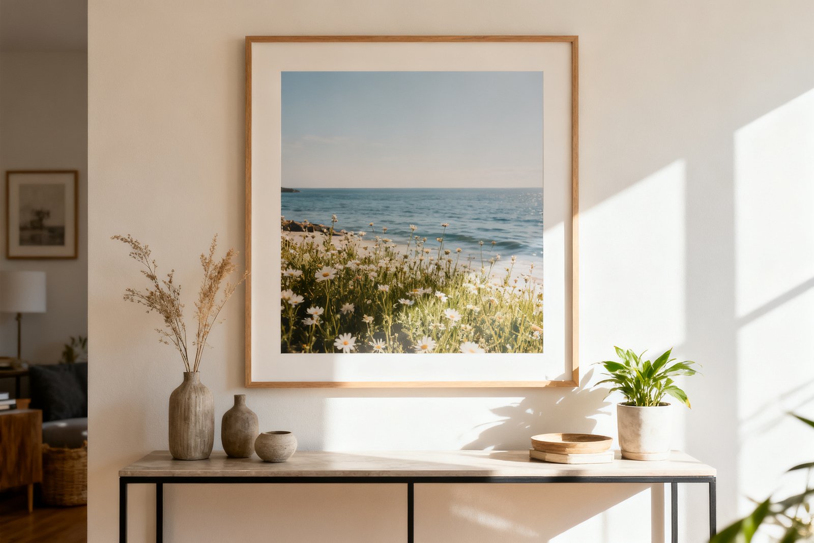 A large framed print centered above a console